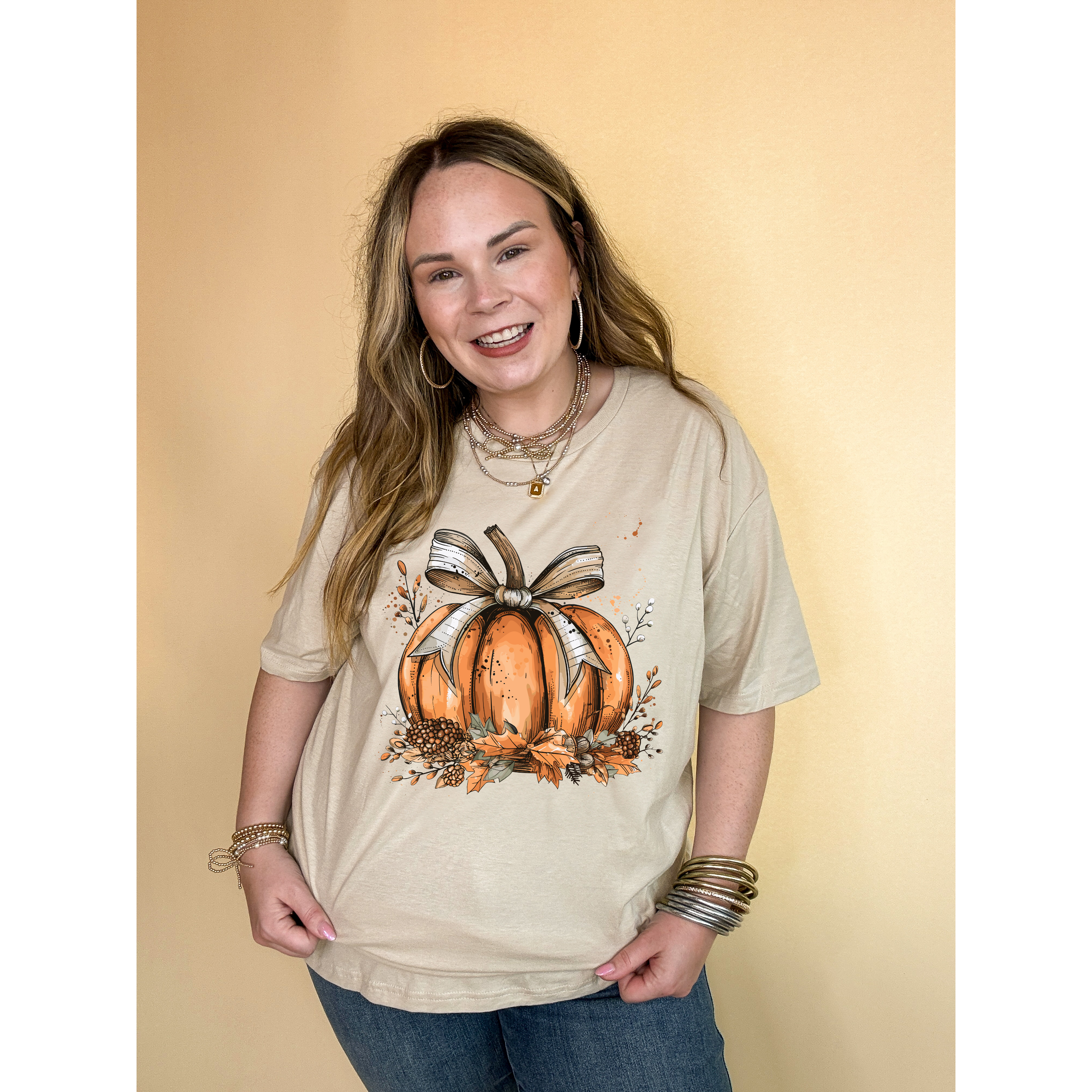 Online Exclusive | Chic Autumn Pumpkin on a Bed of Leaves with White Bow Graphic Tee in Multiple Color Options