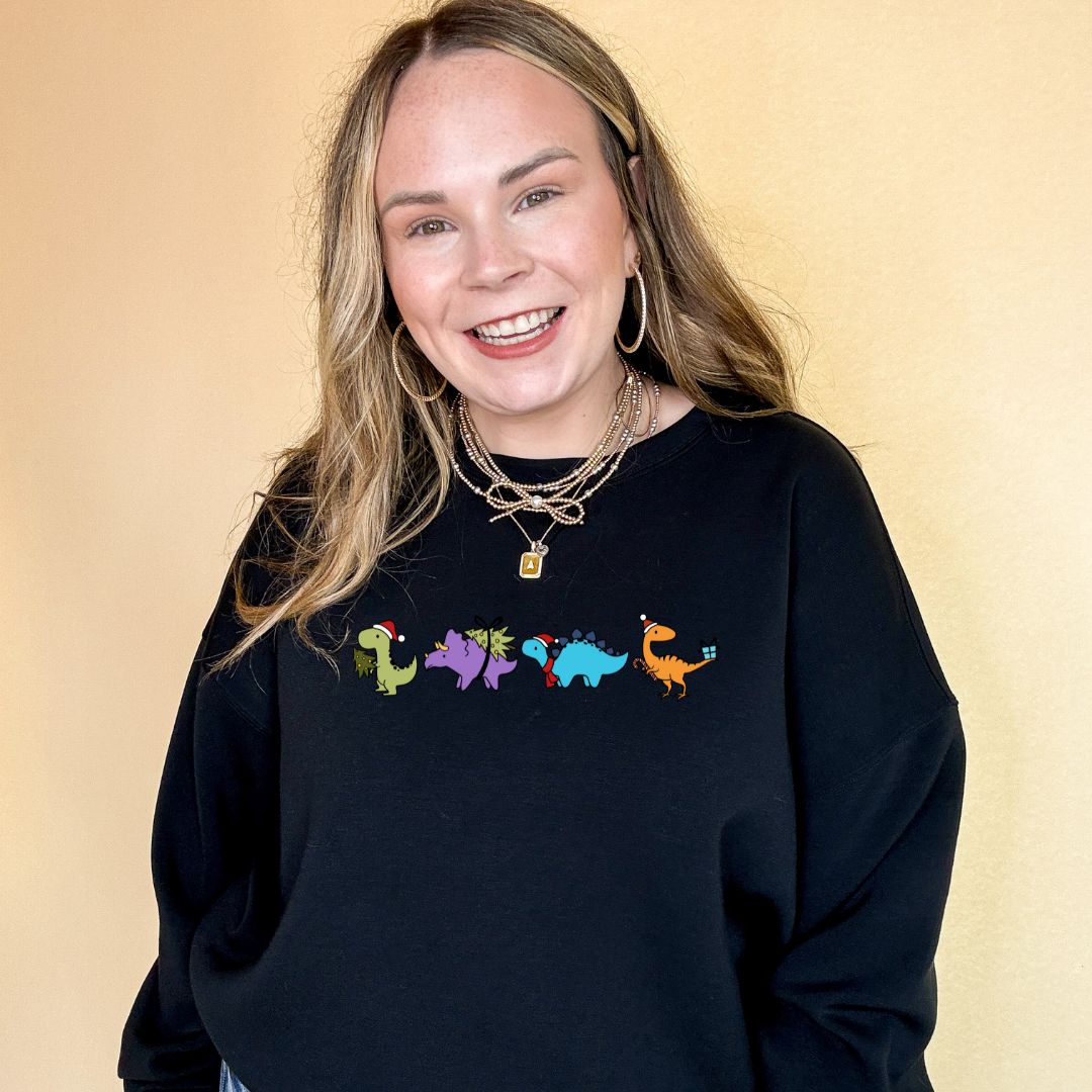 Online Exclusive | Holiday Dinosaur Parade Graphic Sweatshirt in Multiple Color Options