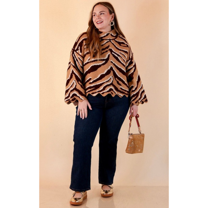 Full length image of a woman wearing the Color Me Wild Zebra Print Mock Neck Bell Sleeve Sweater with Scalloped Hem in Camel