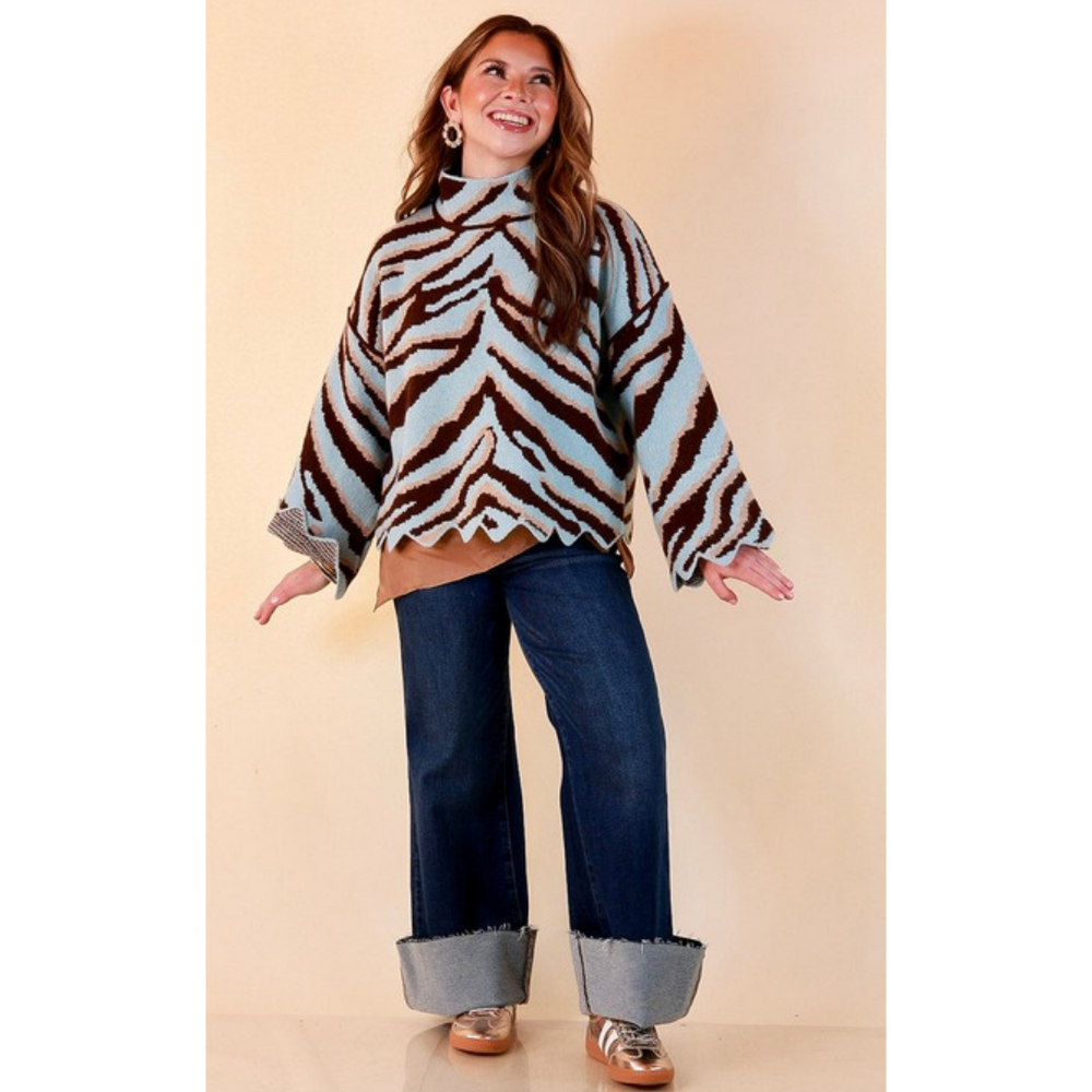 Full length image of a woman wearing the Color Me Wild Zebra Print Mock Neck Bell Sleeve Sweater with Scalloped Hem in Light Blue