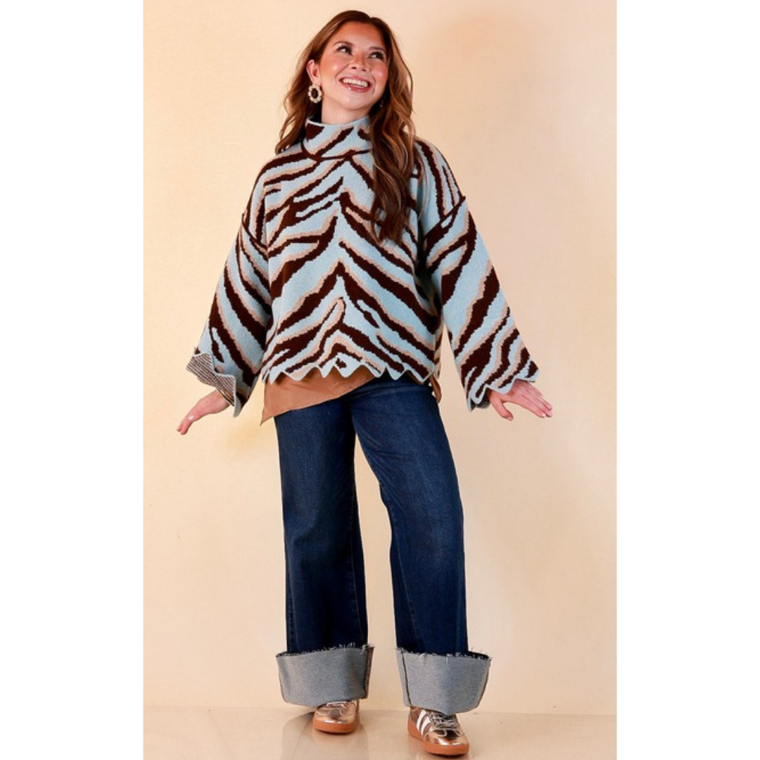 Full length image of a woman wearing the Color Me Wild Zebra Print Mock Neck Bell Sleeve Sweater with Scalloped Hem in Light Blue
