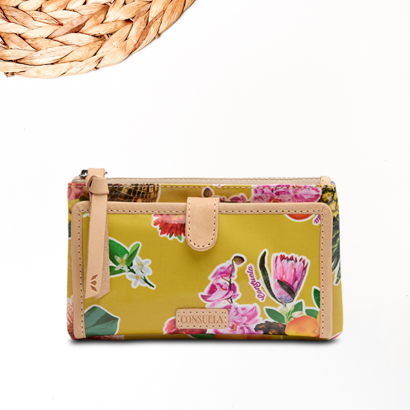 white background with wooden detailing for looks featuring a yellow fun and vibrant consuela cloth print that screams summer. the cloth features lots of fun and colorful flowers.