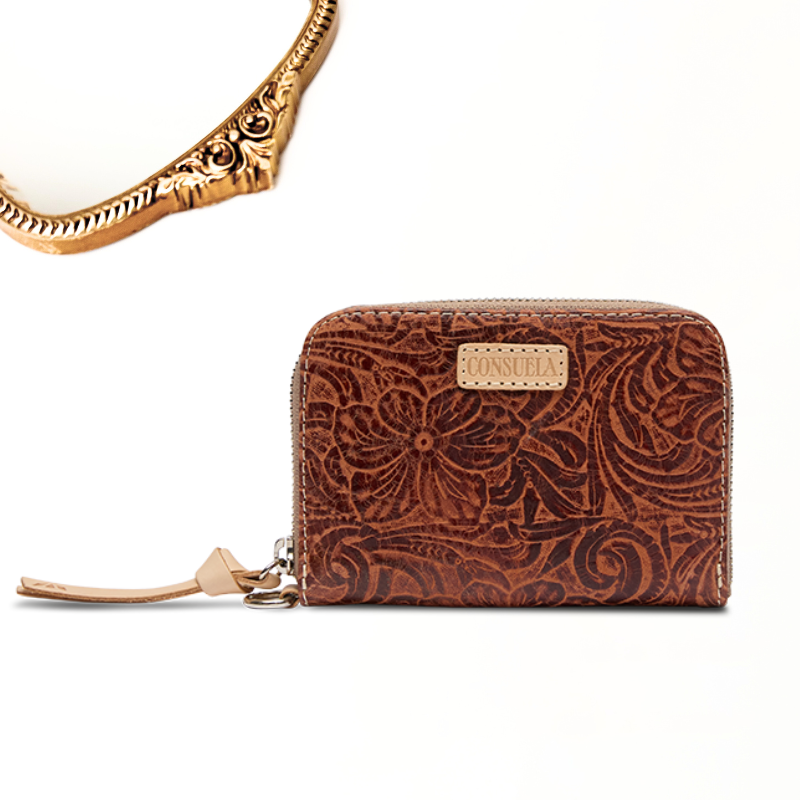 white background with gold mirror detailing featuring a brown tooled leather wallet known as the Sally print