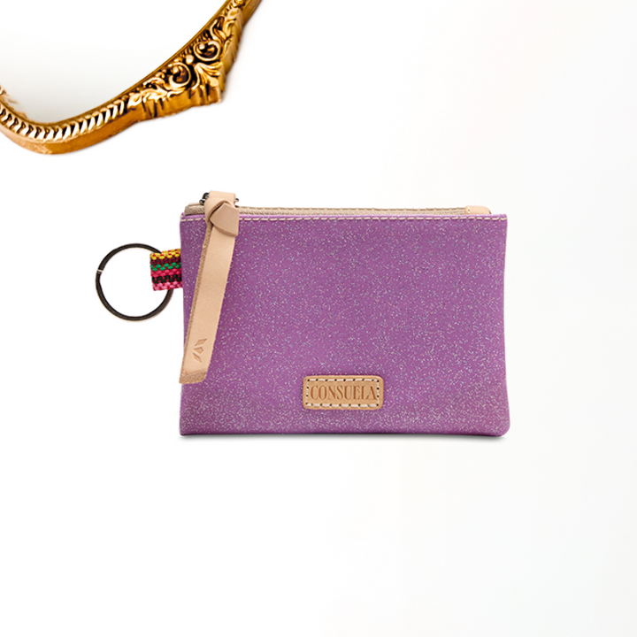 white background with gold mirror for detailing featuring a purple glitter consuela cloth hand sized coin pouch with a zipper and key ring