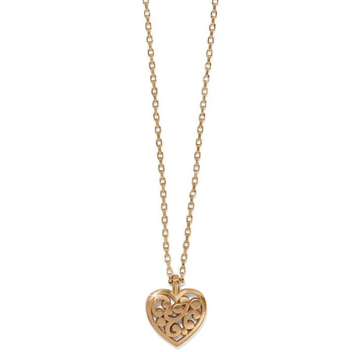 Gold chain and heart pendant necklace on a white background
