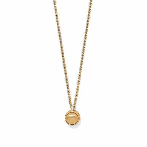 A gold circle pendant necklace on a white background