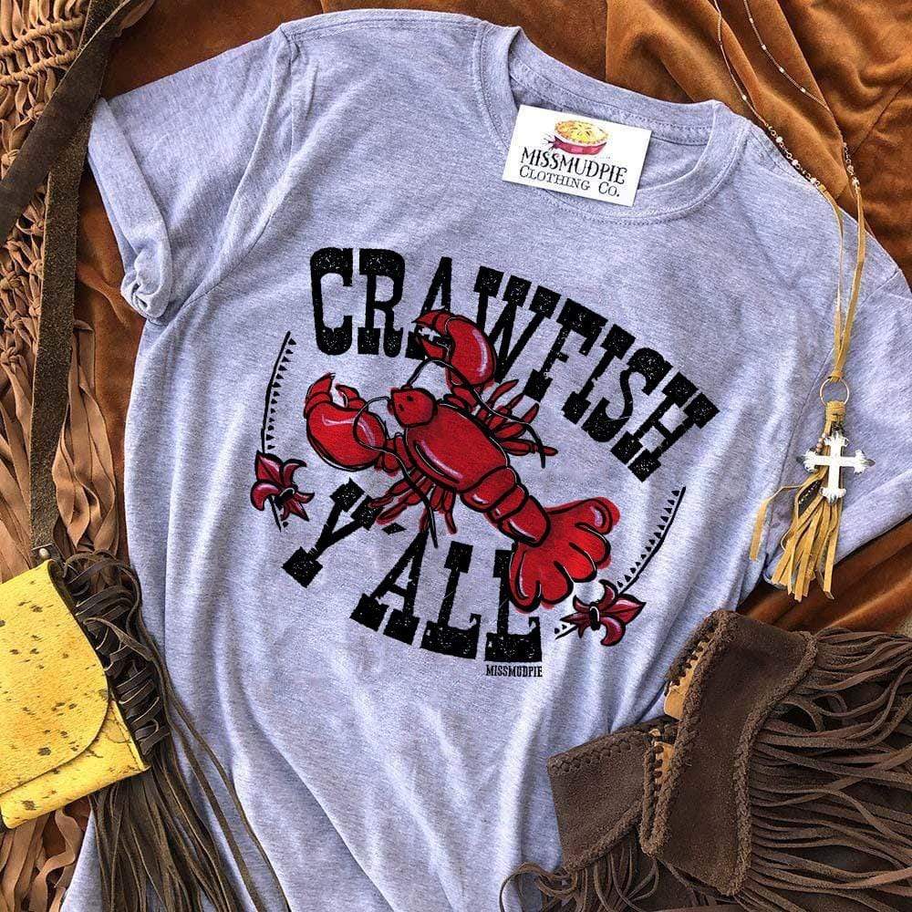 A heather grey short sleeve shirt featuring a graphic of a red crawfish with the text "crawfish y'all" in a black bold text. On the side of the graphic  is a line border with little triangles and a red fleur-de-lis.