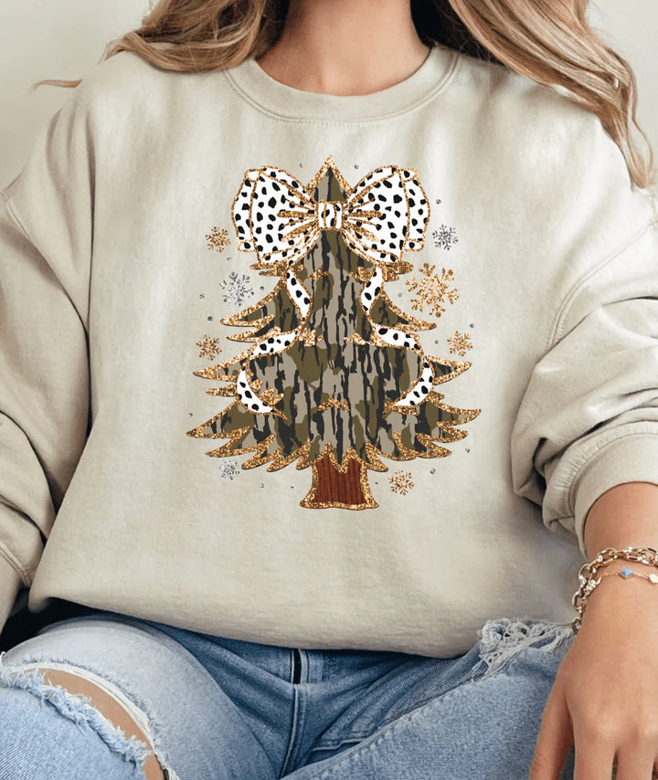Beige sweatshirt with a decorative bow design worn by a person.