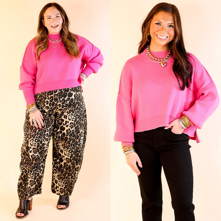 Two models wearing the Fuchsia Pink 'Fireside Fit' cropped long sleeve mock neck sweater with jeans. Against a plain background.