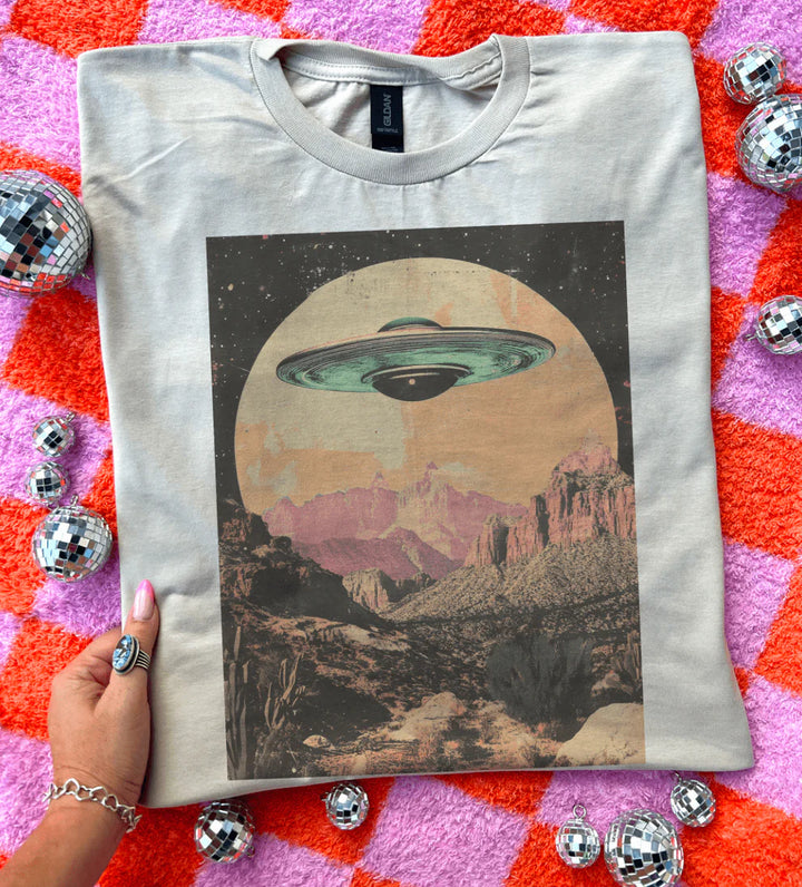 My Ride Is Here graphic tee with UFO & desert landscape design – cream shirt