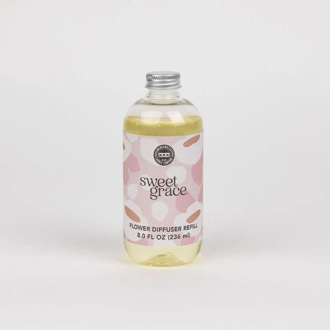 A clear bottle with silver lid, filled with a dye free diffuser refill made for the flower diffuser by bridgewater candle company.