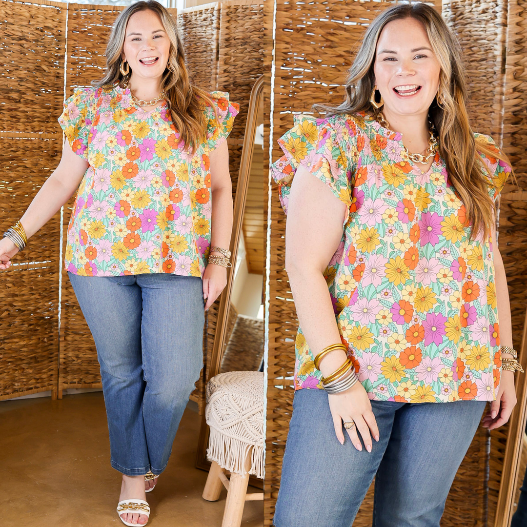 This top features ruffle cap sleeves complemented by the notched neckline. Available in sizes small through 2XL.