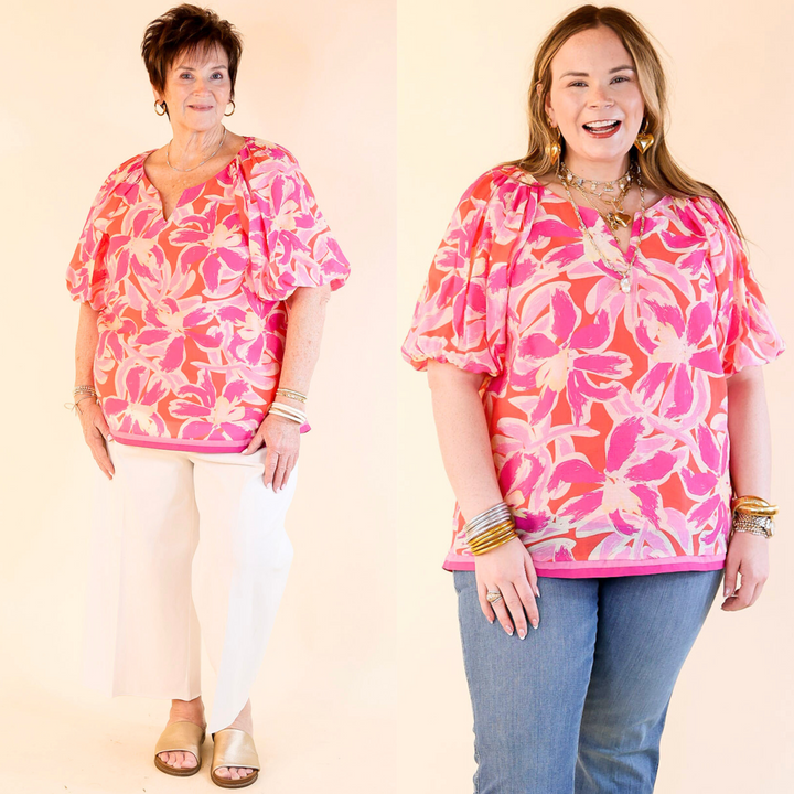 This stunning floral print in shades of pink and magenta, short puff sleeves, and a notched neckline offers a flattering and breathable fit. Sizes small to plus sizes.