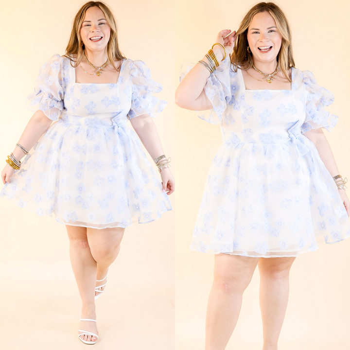 This dress features short puff sleeves, a flattering square neckline, floral print, and an adjustable belt. 