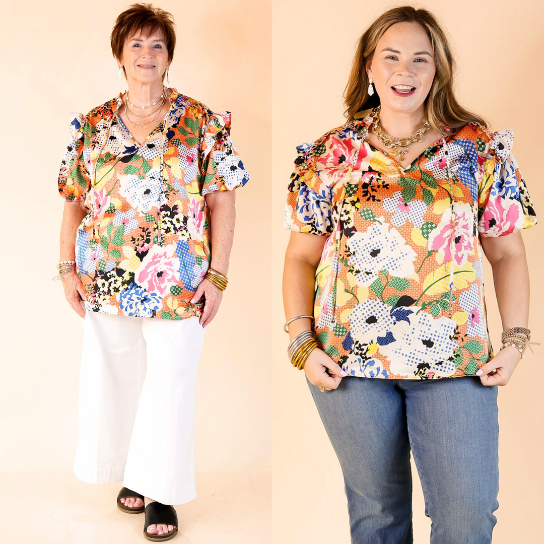 v neck top with tie closure, short puff sleeves, and a floral print. 