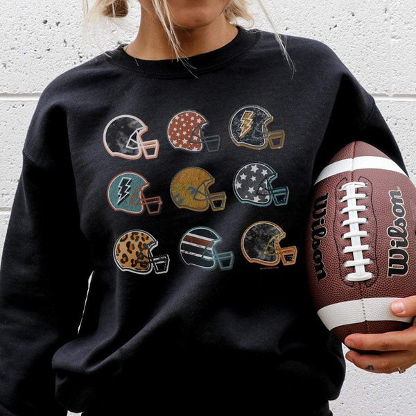 Model is wearing a black sweatshirt featuring a graphic of 9 football helmets, each with their unique pattern.