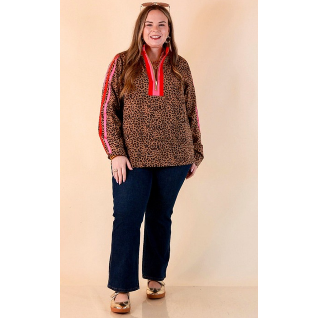 Full length image of a woman wearing the Front Runner Leopard Print Quarter Zip Long Sleeve Pullover Top with Stripe Trim in Tan, Red and Pink