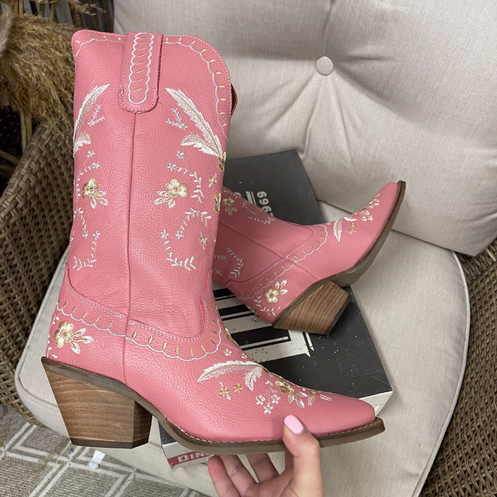 Pink leather cowboy boots with cream floral embroidery, a pointed snip toe and stacked wooden heel.