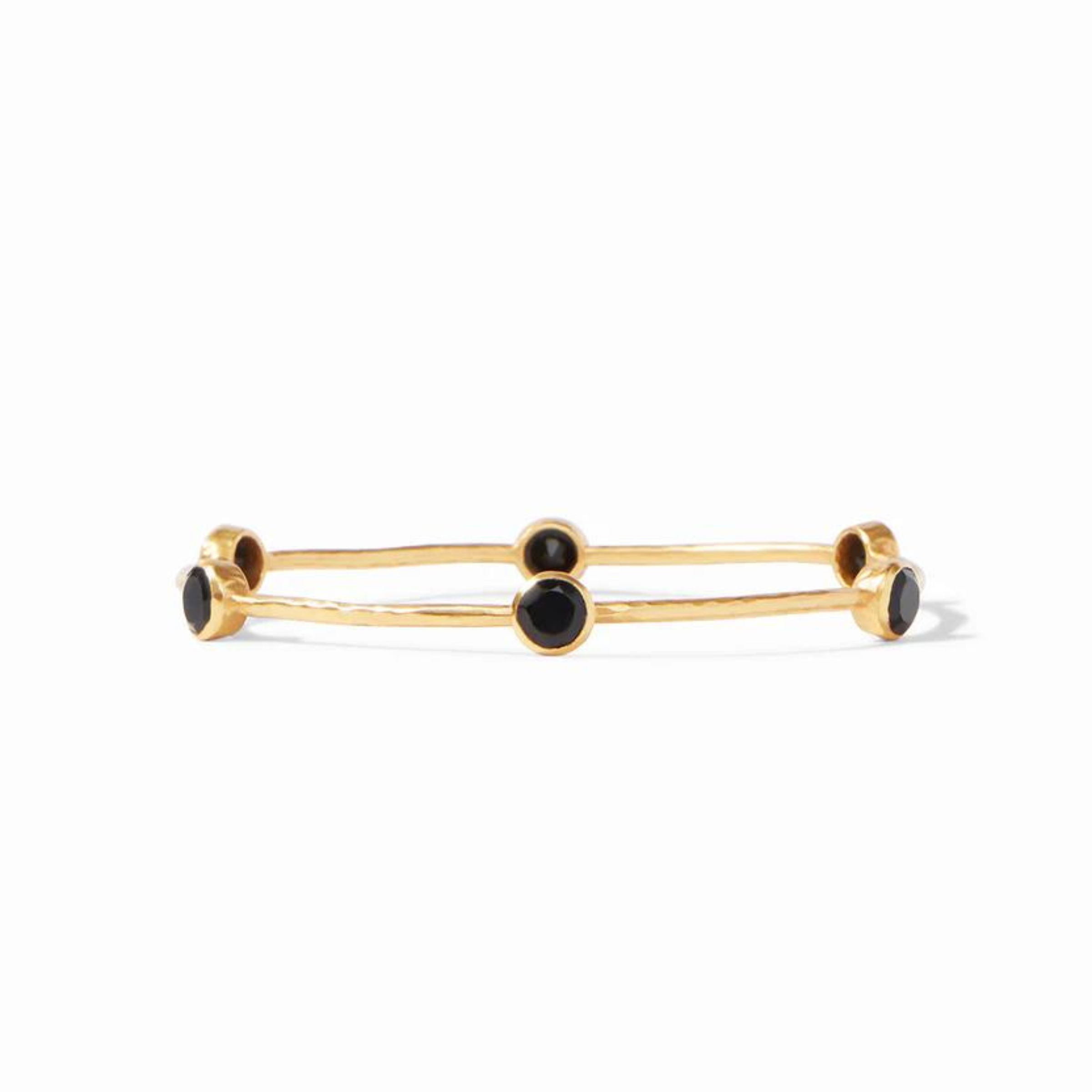 Gold bangle with black crystals pictured on a white background. 