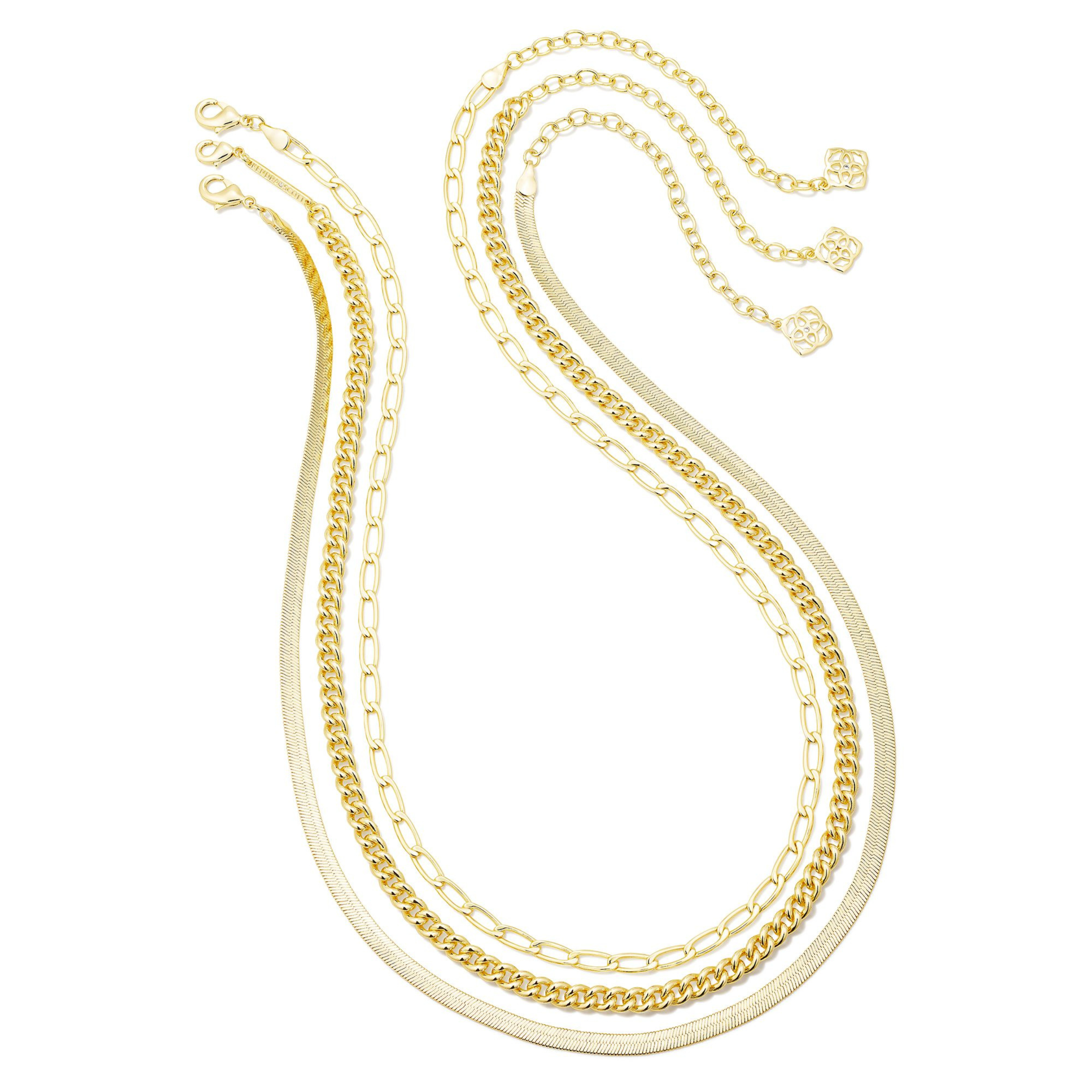 Three chain necklaces pictured on a white background. 