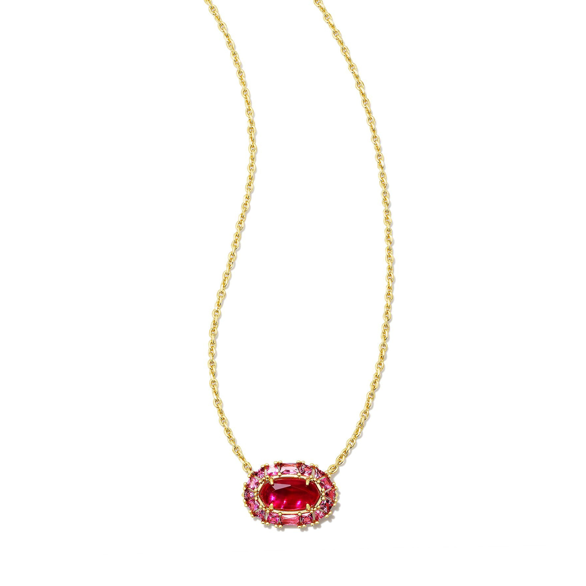 Gold chain necklace with a clear crystal and raspberry illusion oval pendant pictured on a white background. 
