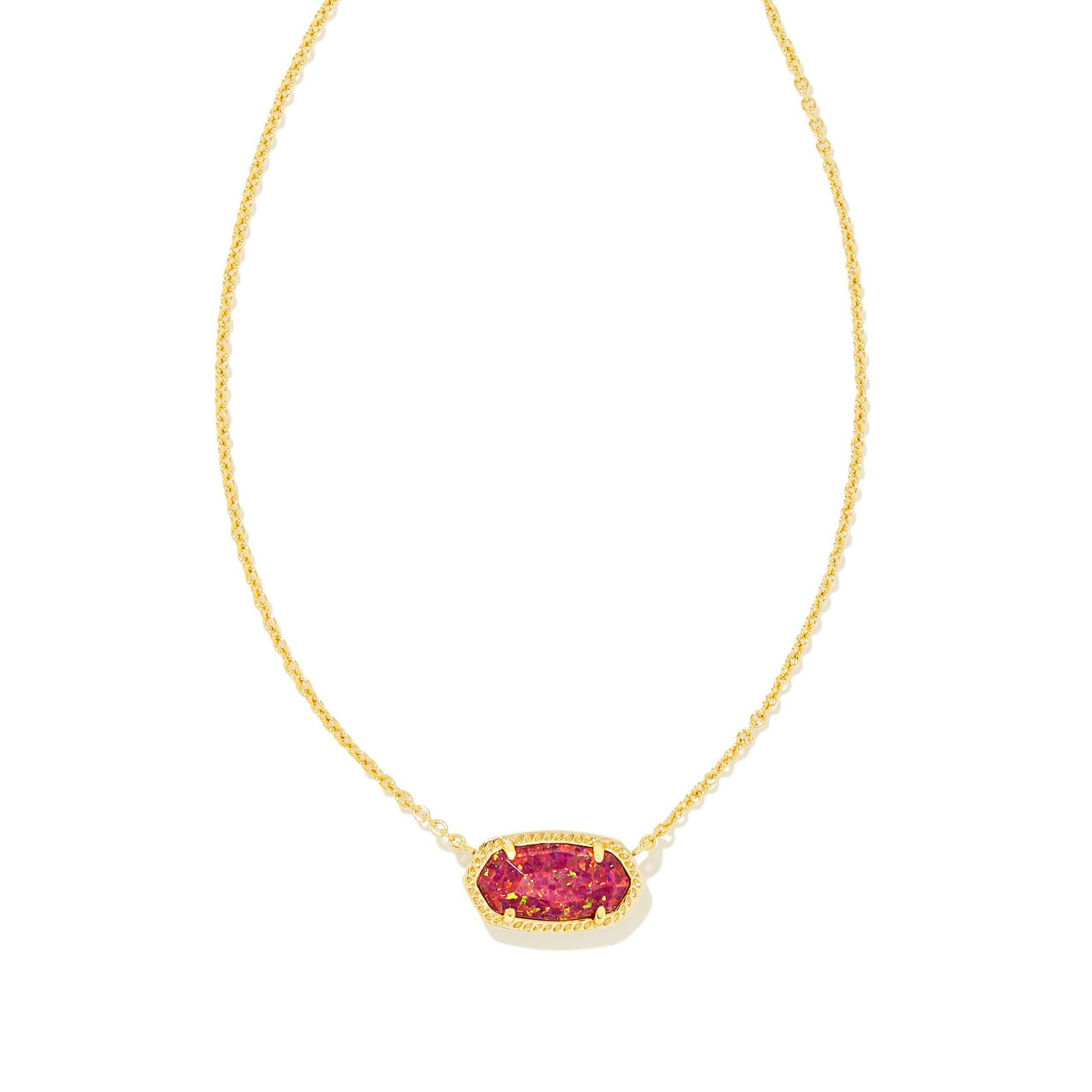 Pictured on a white background is a gold chain necklace with a gold pendant that includes a red opal stone. 