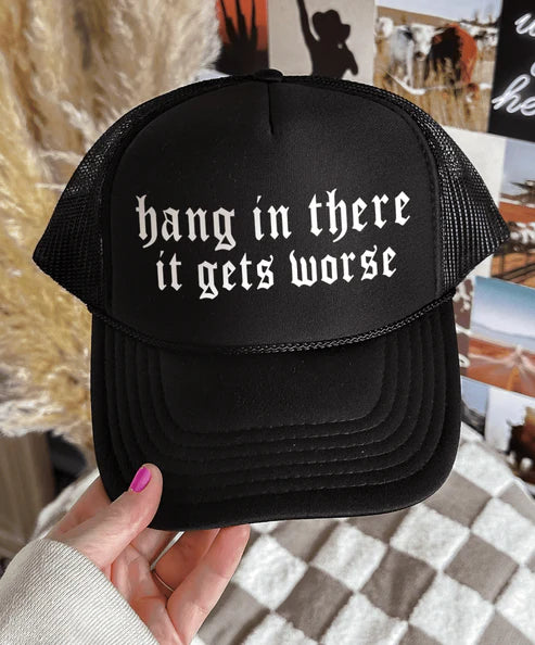 Black foam trucker hat featuring the phrase Hang In There It Gets Worse in bold vintage-inspired lettering.