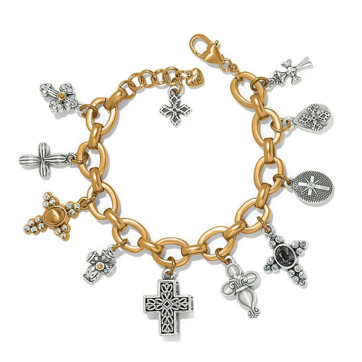 Gold and silver charm bracelet with various charms on a white background