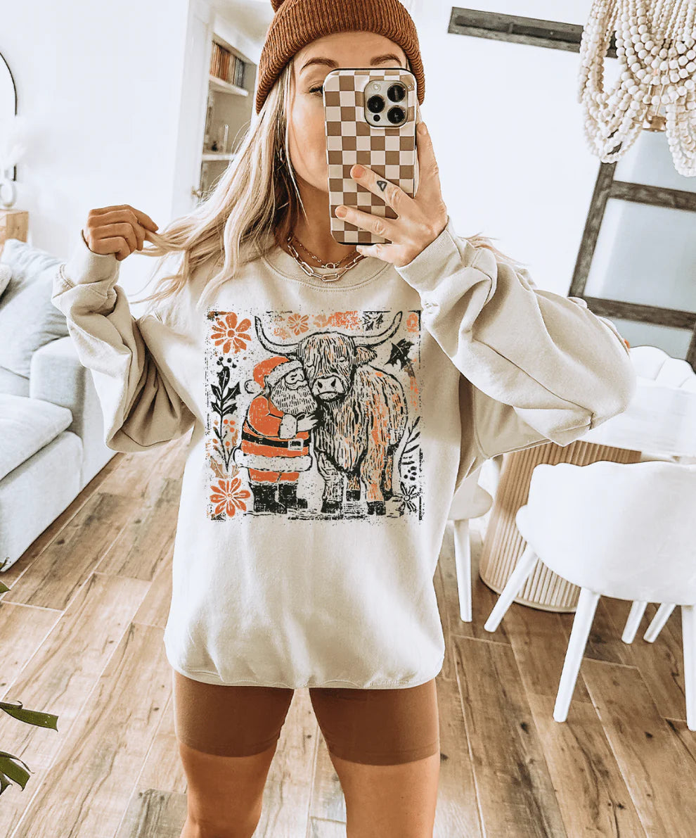 Cream sweatshirt with Highland cow and Santa holiday graphic in farmhouse style
