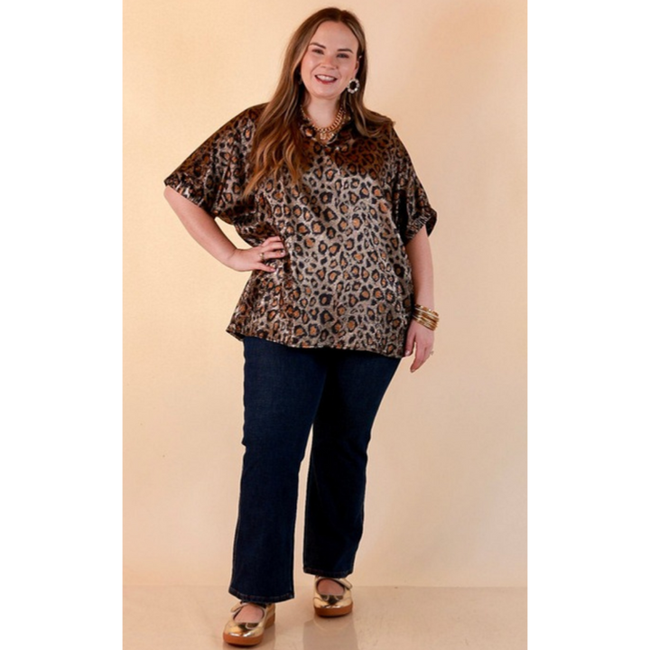 Full length image of a woman wearing the Hits the Spot Metallic Leopard Print Short Sleeve Split Neck Top with Ruffle Collar in Black