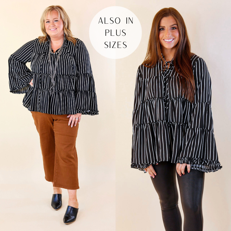 Models are wearing a black and white striped blouse. Plus size model has this paired with brown pants, black heels, and silver jewelry. Small model has it paired with black pants.