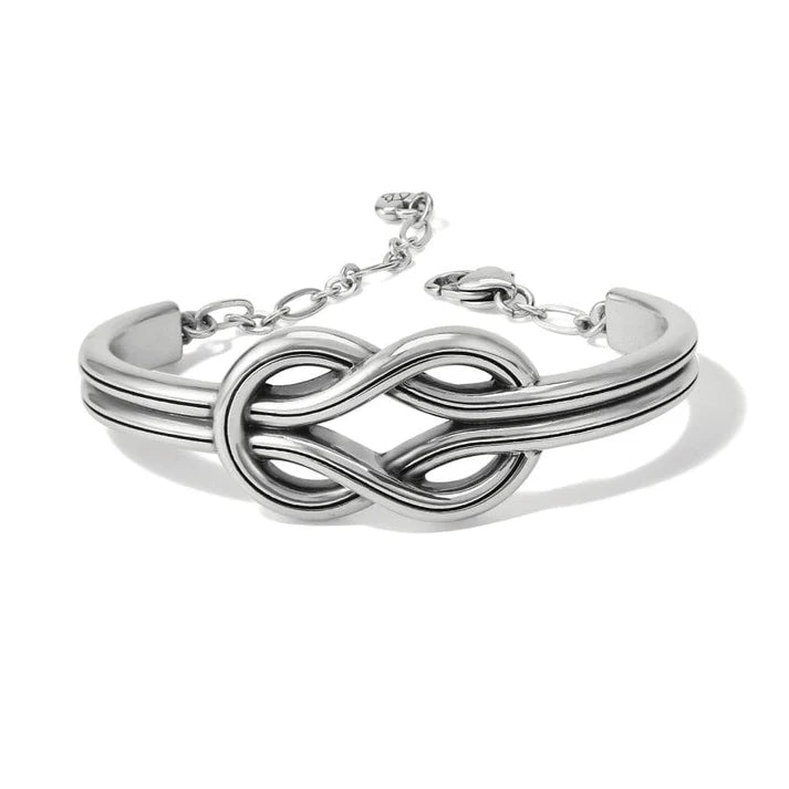 Silver bracelet with a knot design on a white background