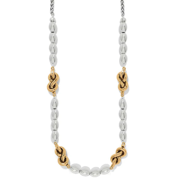 Necklace with alternating silver and gold beads on a white background