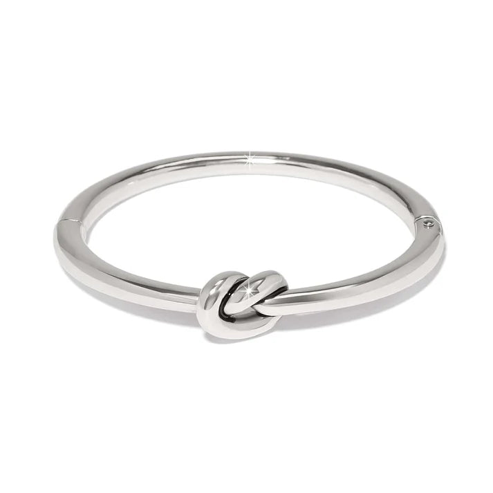 Silver bracelet with a knot design on a white background