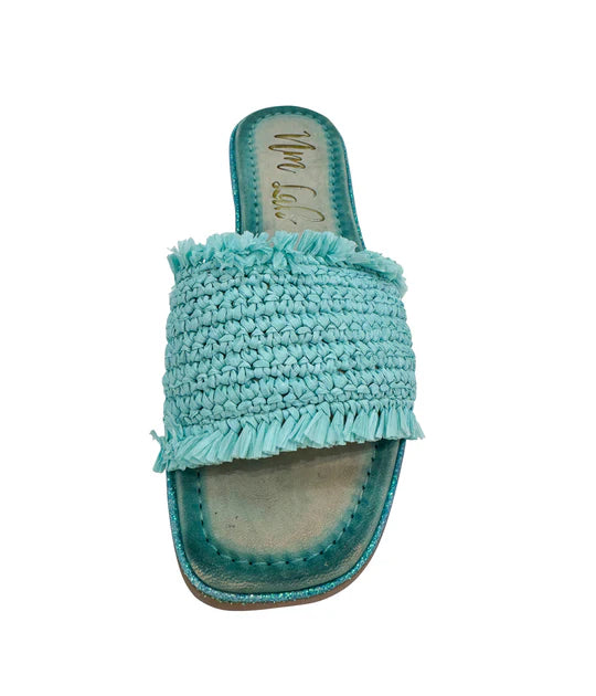 Light blue woven sandal with fringe on a white background
