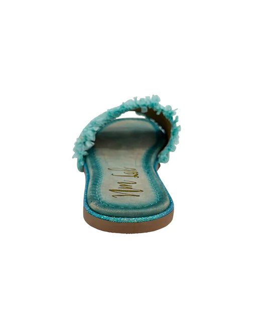 Turquoise sandal with pom-pom details on a white background
