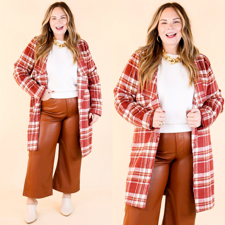 A model wearing a long plaid maroon jacket with a collared neckline and open front, paired with brown leather pants.