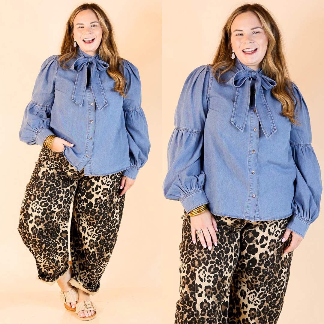 long sleeve button up denim top with a bow tie around the neck that is detachable.
