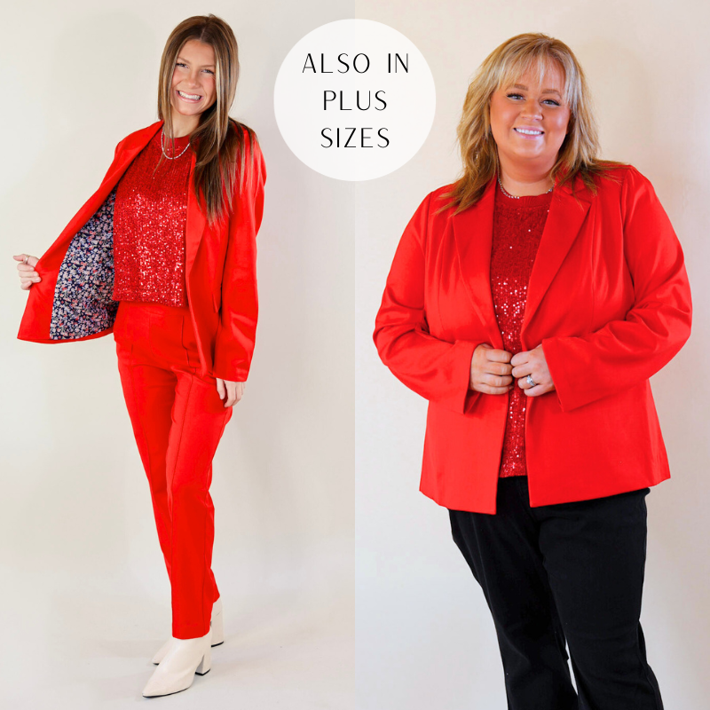 Models are wearing a red blazer with long sleeves. Size small model has it paired with matching red trousers, white booties, and a silver necklace. Size plus model has it paired with black pants and silver jewelry. 