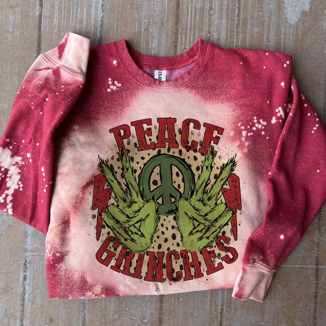 Online Exclusive | Peace Grinches Long Sleeve Bleached Splatter Graphic Sweatshirt in Red - Giddy Up Glamour Boutique