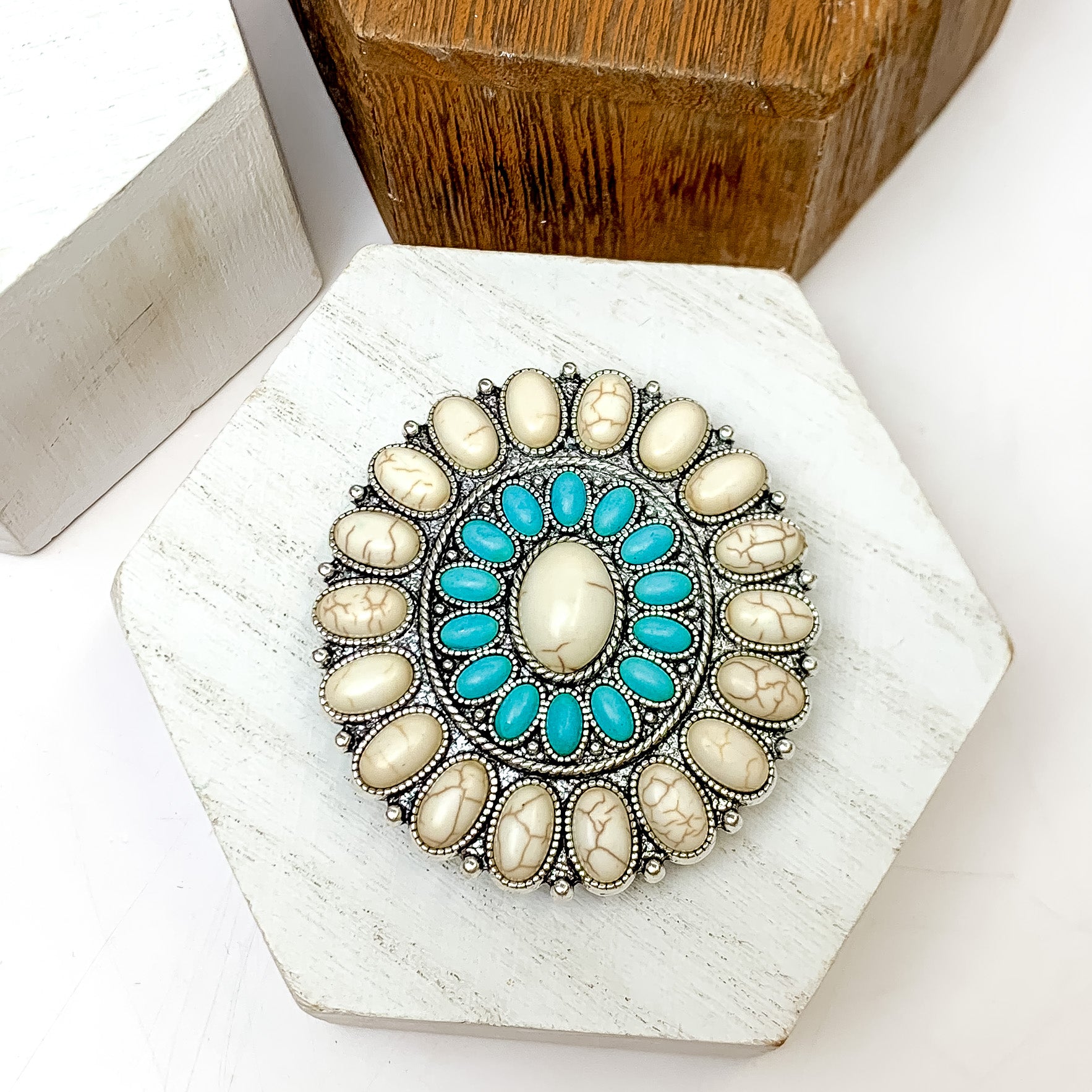 Silver Tone With Turquoise and Ivory Stone Circle Phone Grip. This phone grip is pictured on a white block with a white background behind it.
