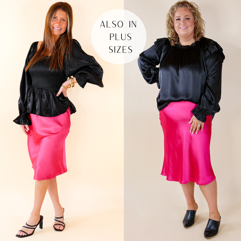 Pink mid length satin skirt. The model is wearing a size small. She paired it with a black blouse and black shoes. The model on the right is wearing a 2X. She also paired it with a black blouse and black shoes.