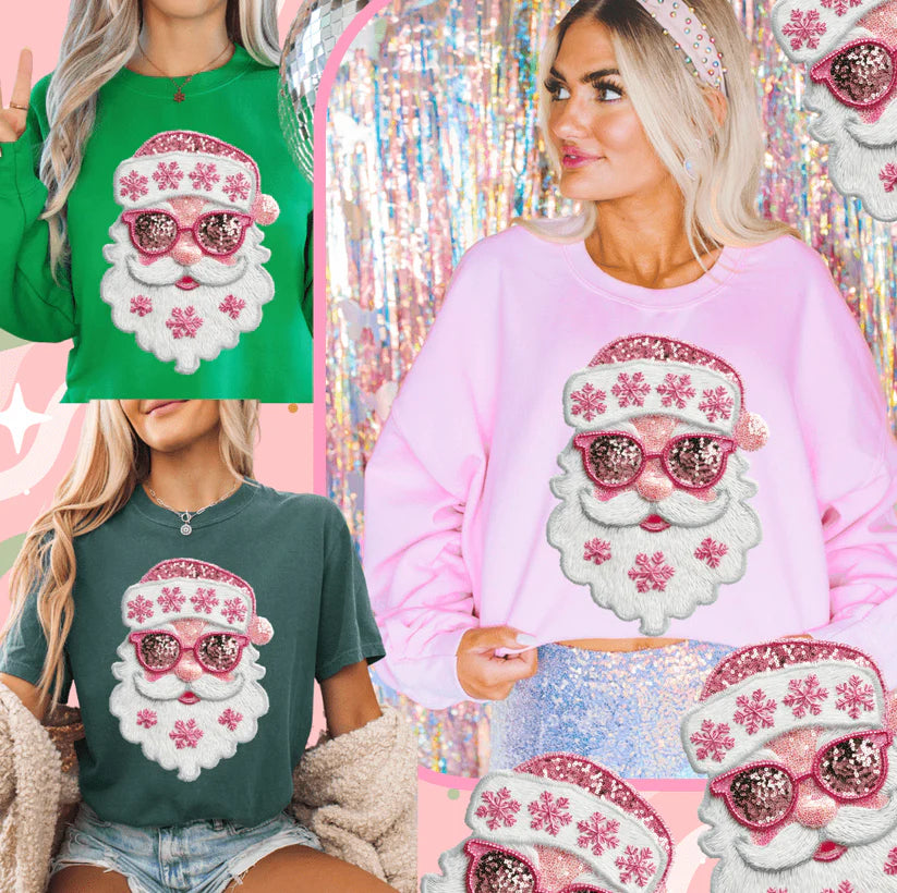 Woman wearing Pretty Pink Faux Sequin Santa Graphic Tee in Blue Spruce, featuring pink sequin-look Santa design with snowflakes.