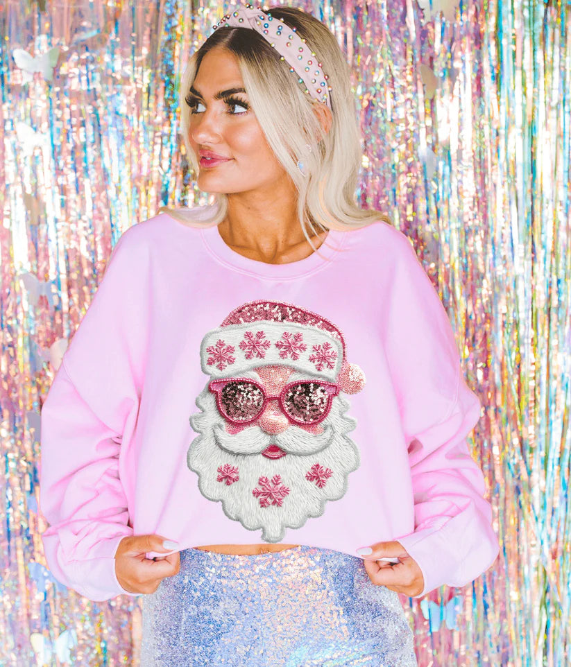 Woman wearing Pretty Pink Faux Sequin Santa Graphic Tee in Blue Spruce, featuring pink sequin-look Santa design with snowflakes.