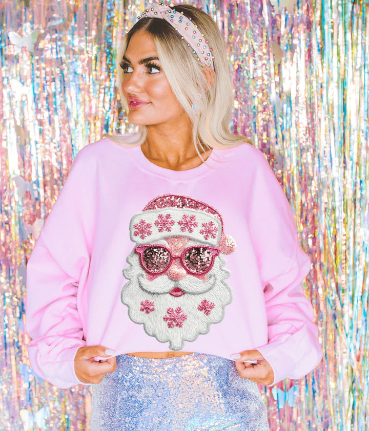 Woman wearing Pretty Pink Faux Sequin Santa Graphic Tee in Blue Spruce, featuring pink sequin-look Santa design with snowflakes.
