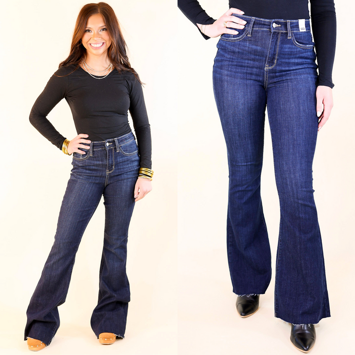 models is wearing dark wash flare jeans on beige background 