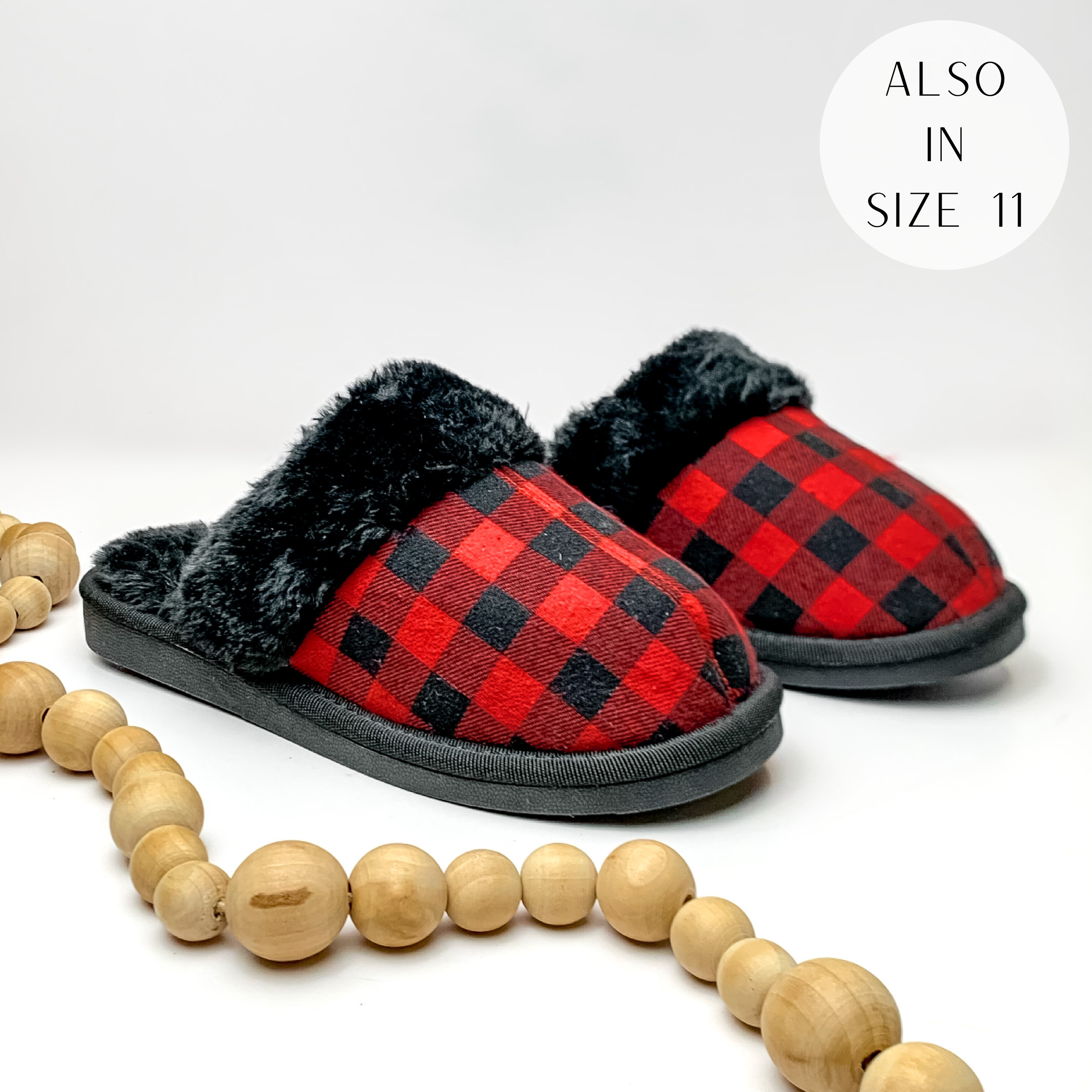 Red plaid slippers with black fur lining and black sole. Pictured on white background with ligh tan beads.