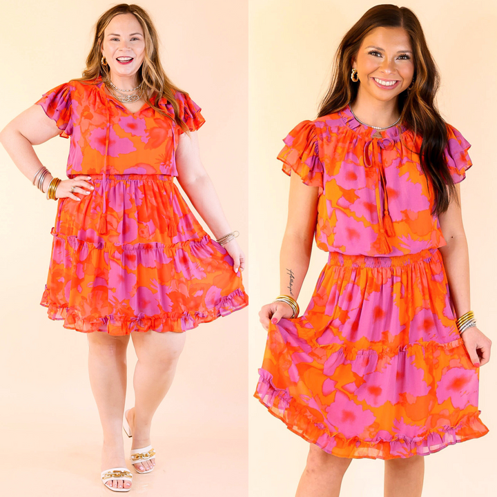 Mix of bold purple and fiery orange, this dress features ruffle sleeves, neckline, and hem, a tiered skirt and scrunched waist. Sizes small to large.