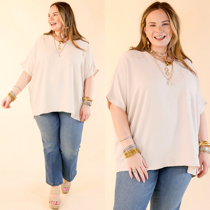 This top includes short drop sleeves, a v neckline, a front pocket, and an oversized fit. Available in sizes small through plus size. 