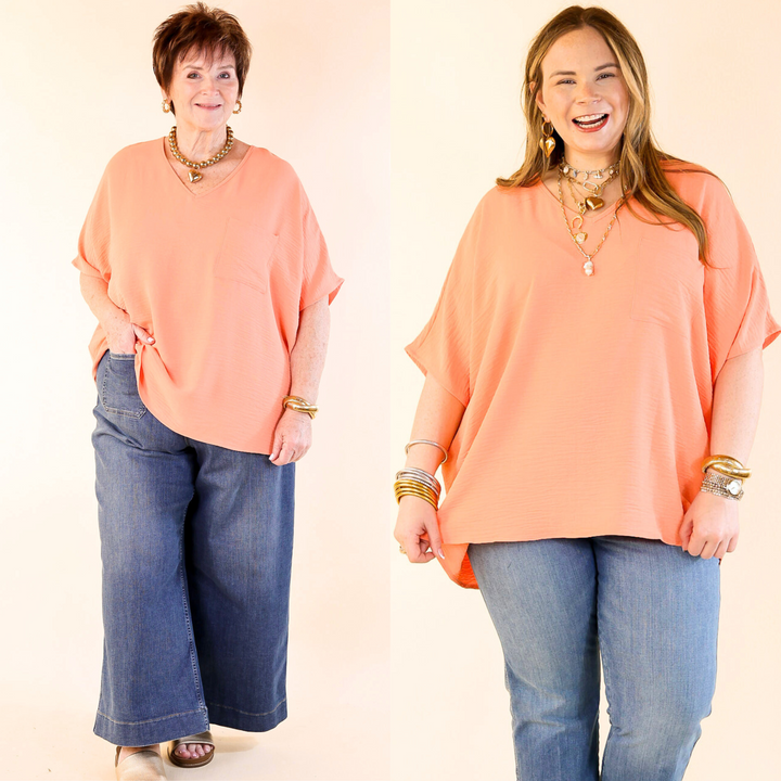This cute top includes short drop sleeves, a v neckline, a front pocket, and an oversized fit. Available in sizes small through plus size. 